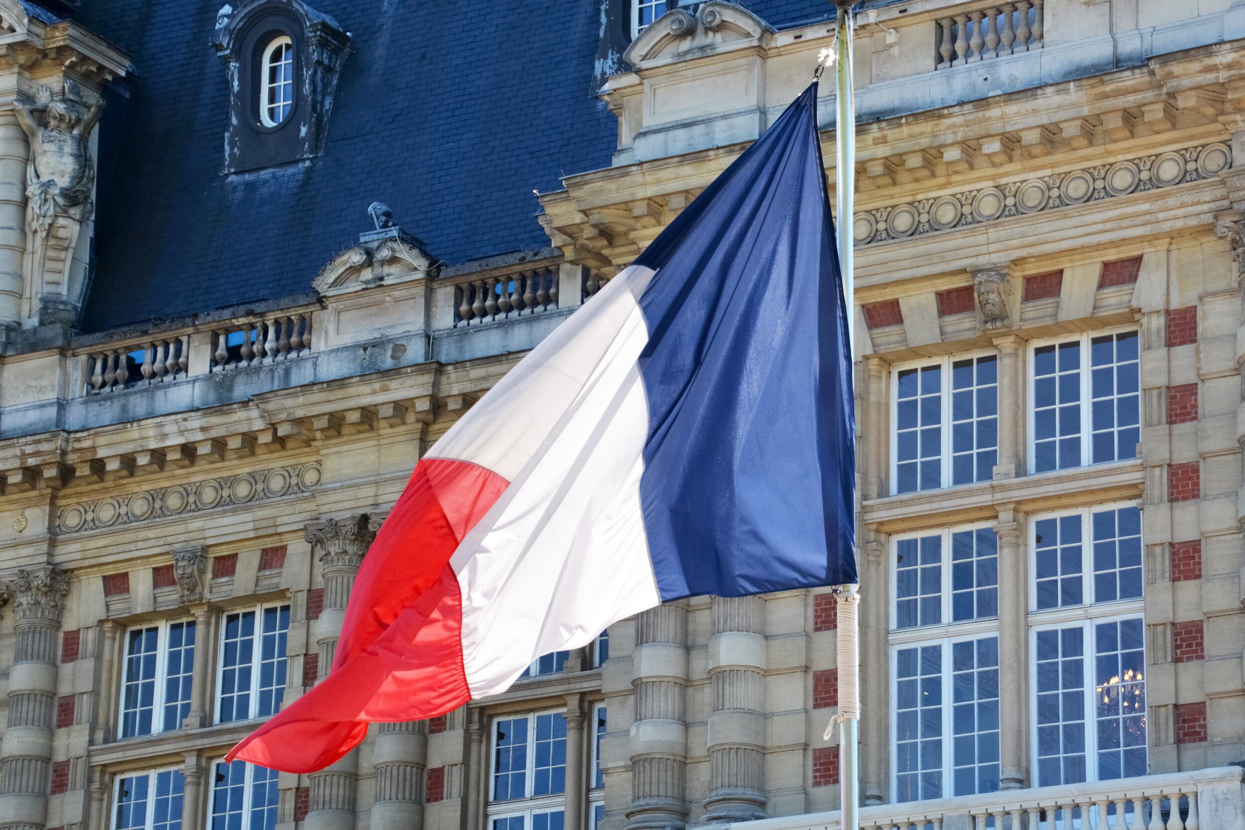 French flag flying outside of building