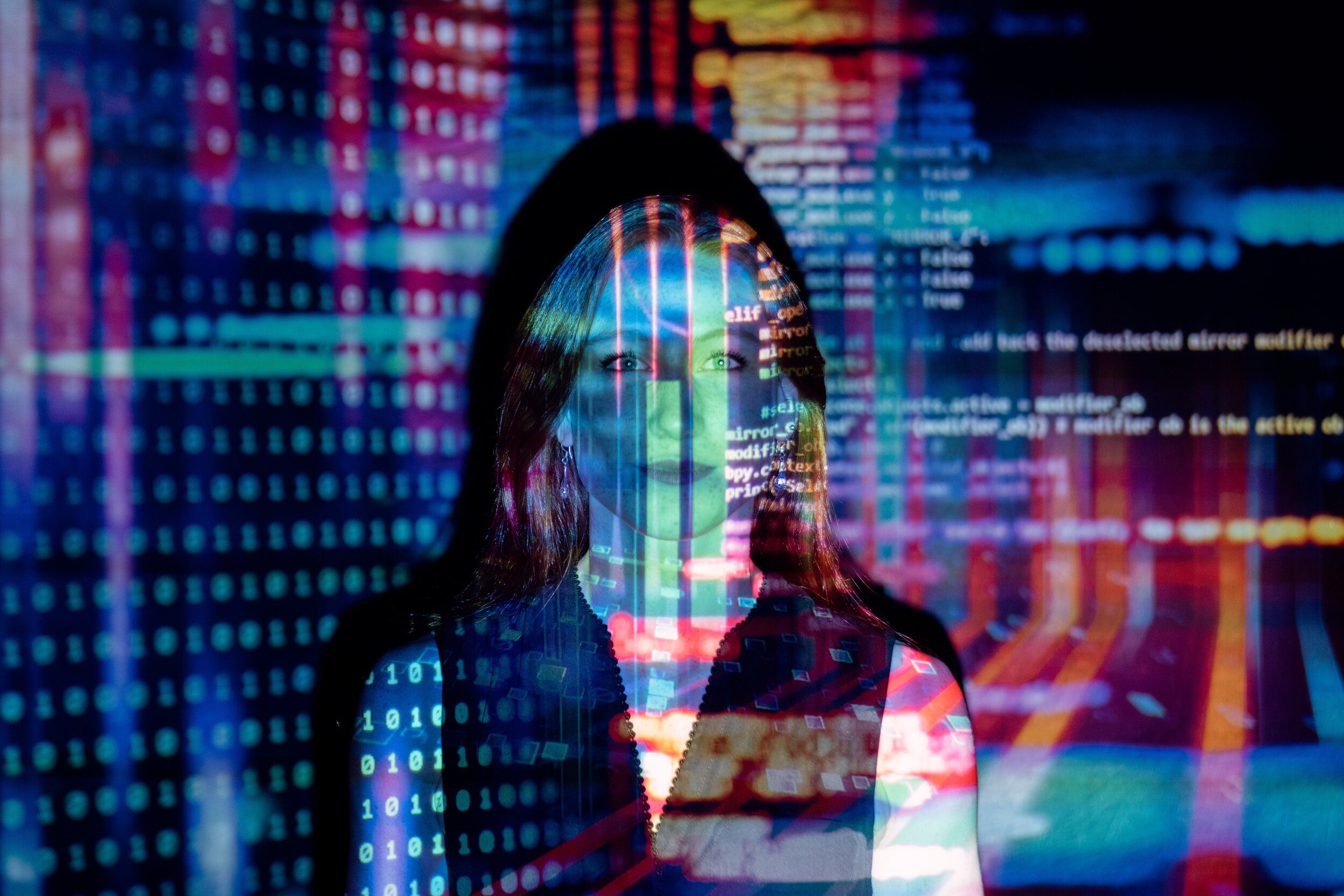 Woman standing in front of projected code