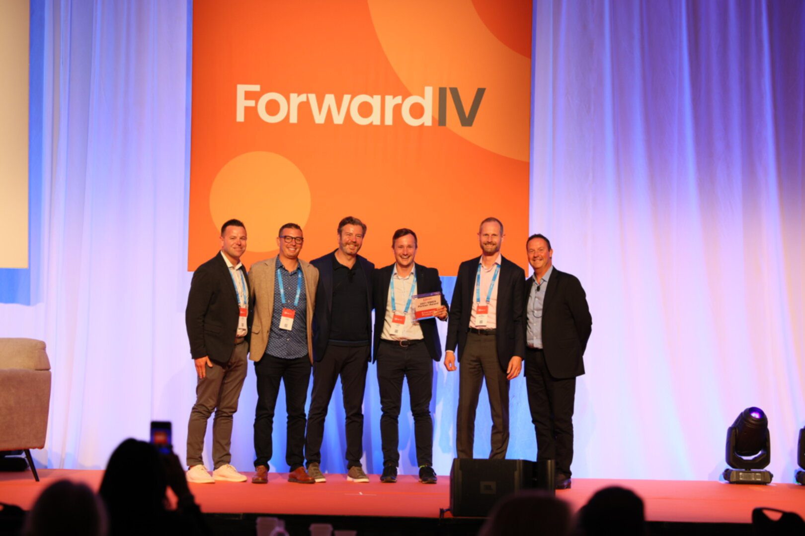 Roboyo team accepting award on stage at Forward