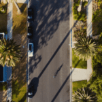Birdseye view of a street with trees lined either side of road