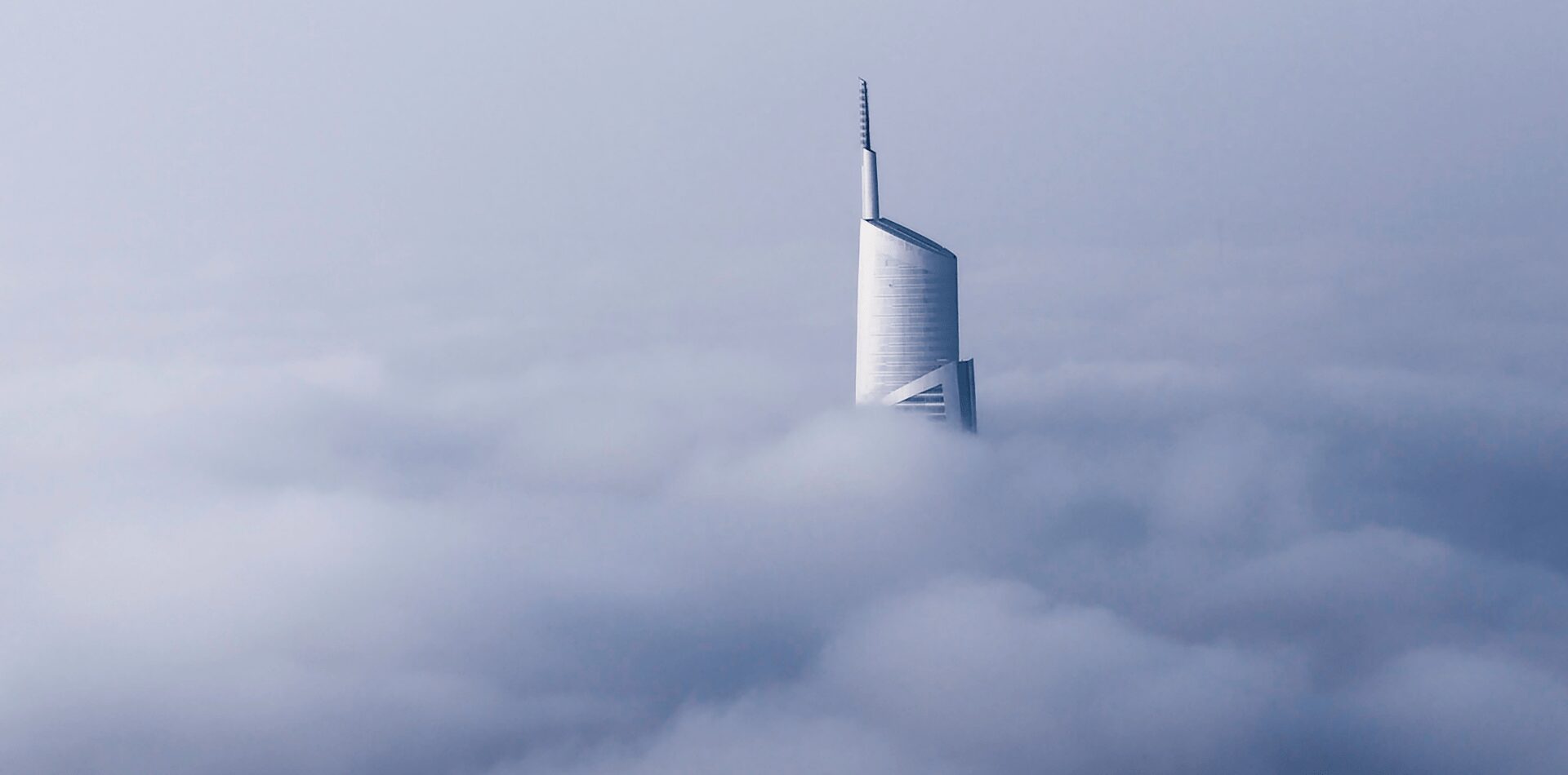 Skyscraper building coming out of the clouds