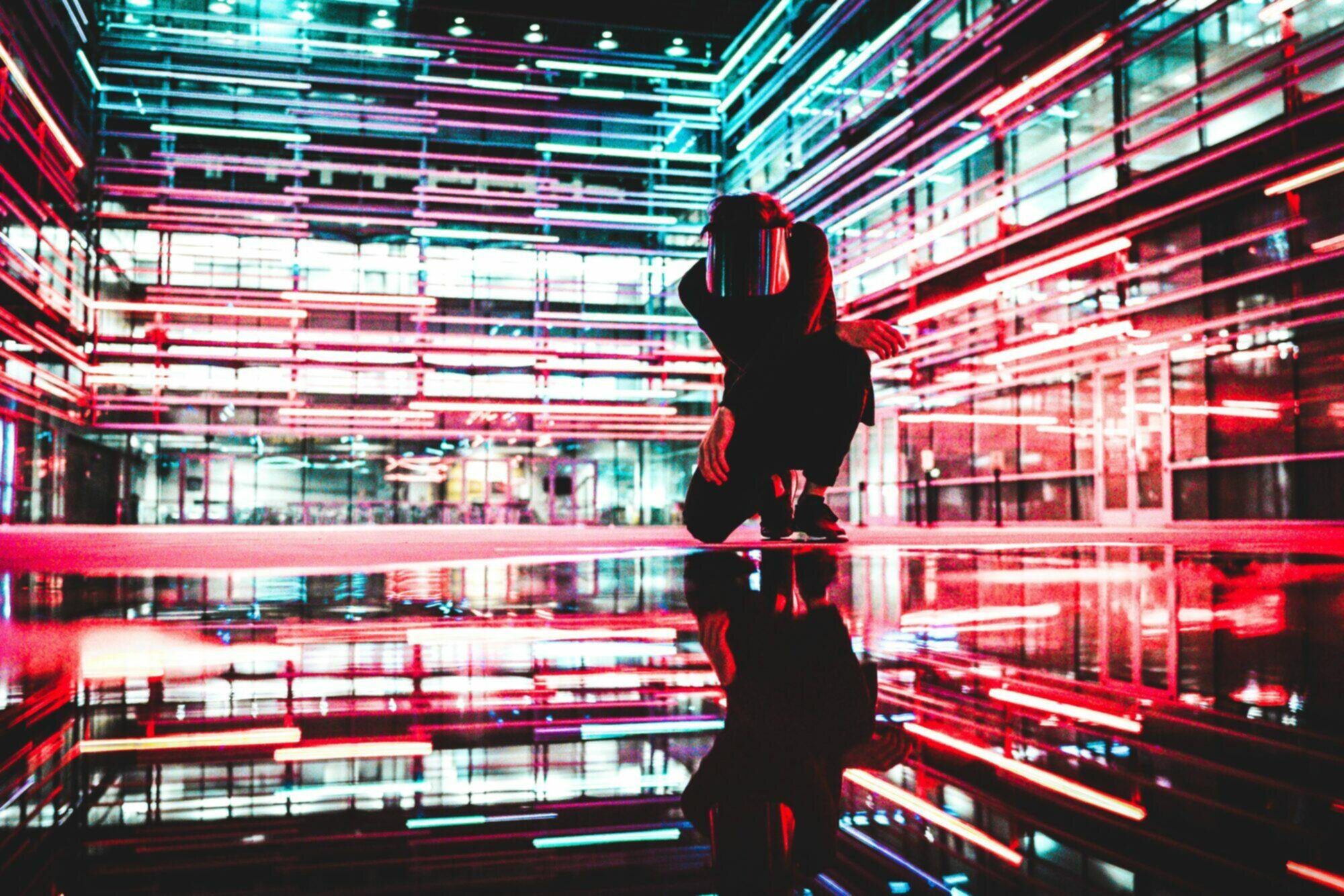 Man kneeling down in light filled futuristic room