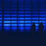 blue background with two people silhouetted