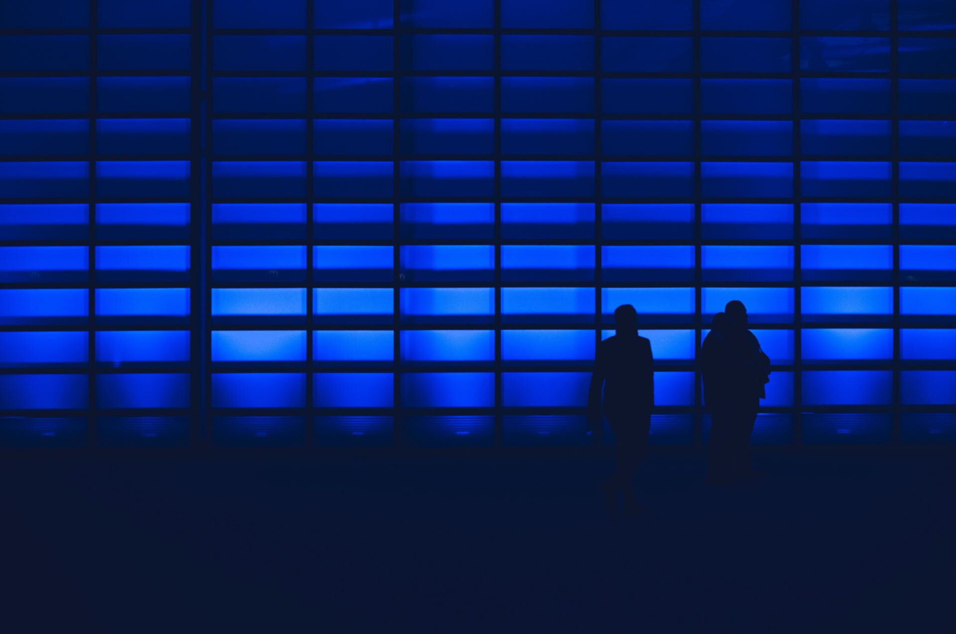 blue background with two people silhouetted