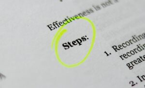 The word 'steps' written in bold and circled in yellow highlighter on a page