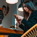 Woman looking at mobile phone in cafe