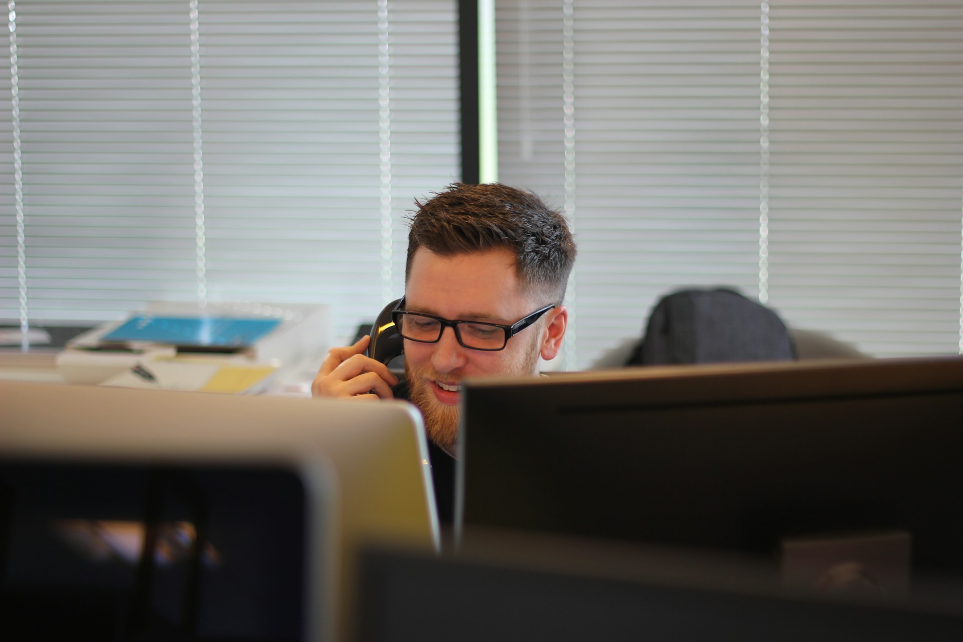 Man using phone in office setting